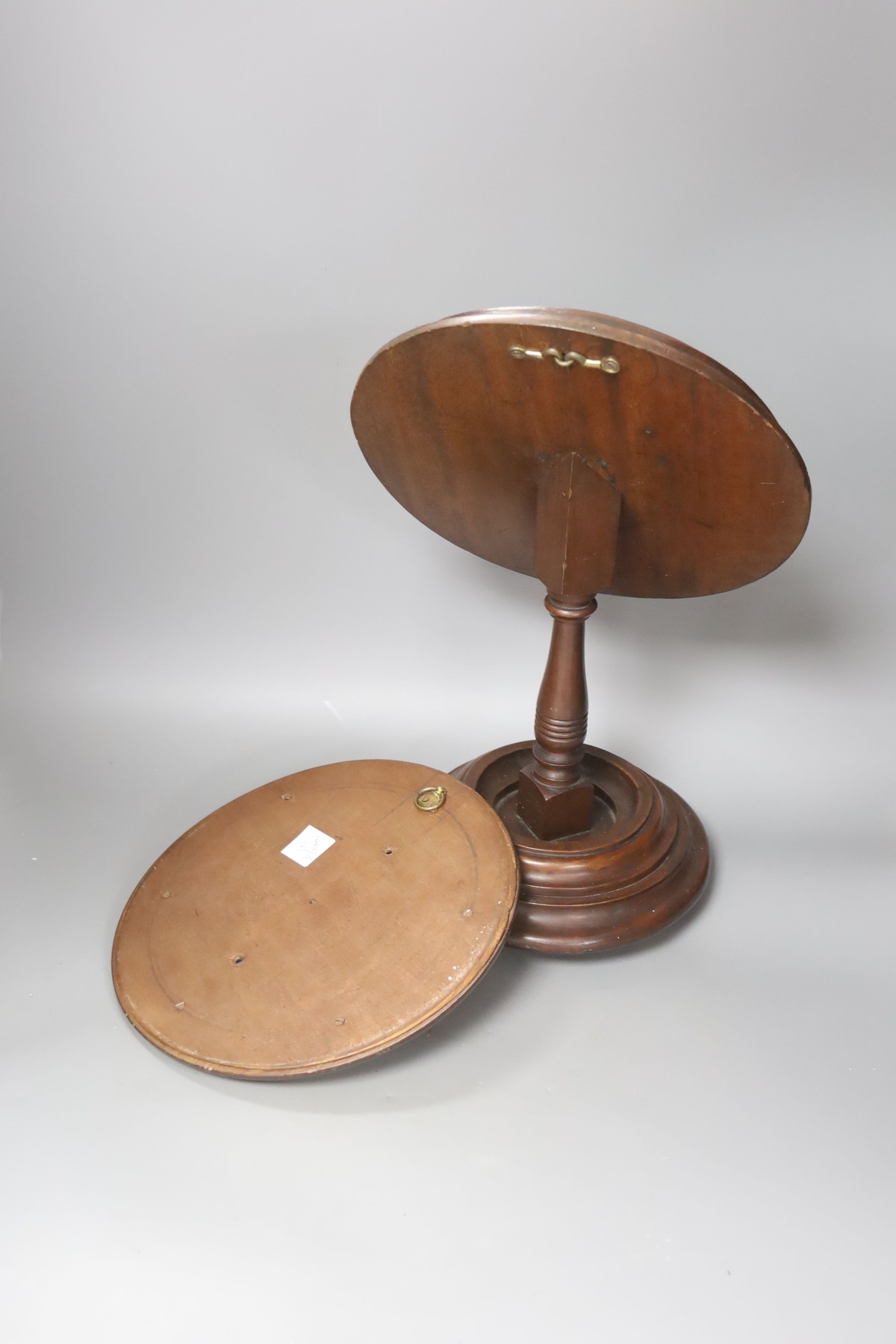 An oval mahogany-framed pedestal shaving mirror and circular mahogany picture frame